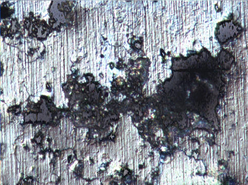 Corrosion pitting into an aluminum surface